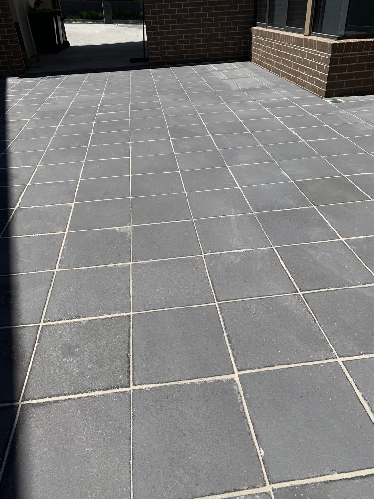 Residential garden with stone paving and lawn