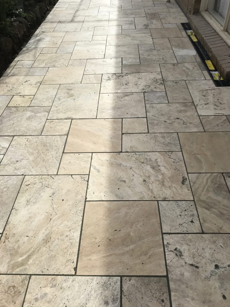 "Garden with stone paving and lush greenery"