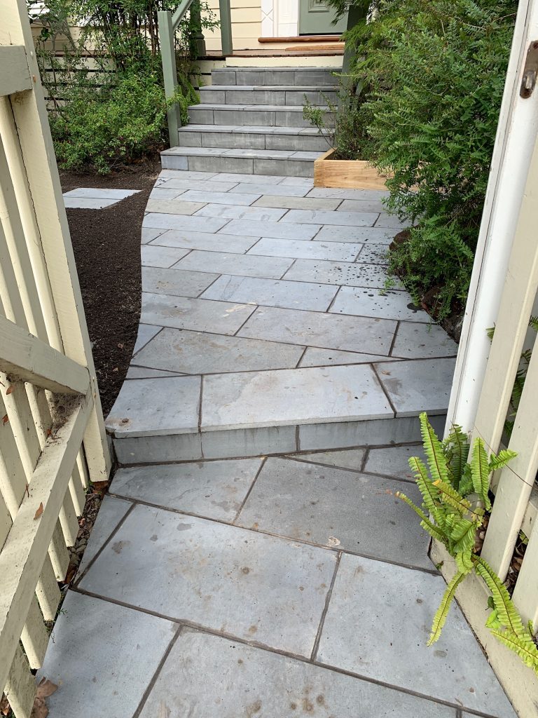 "Residential garden with paved stone paths"