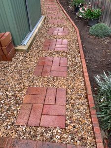 "Residential garden with stone pathways and plants"