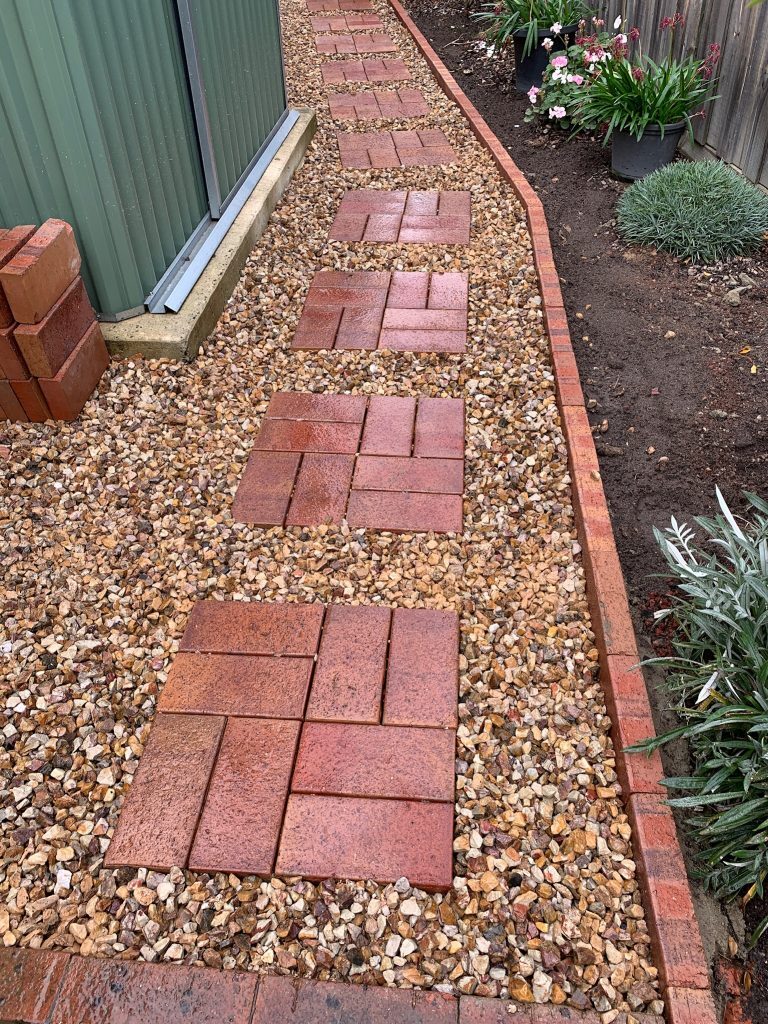 "Residential garden with stone pathways and plants"