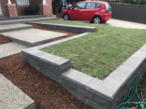 "Neatly paved stone path through a landscaped garden"