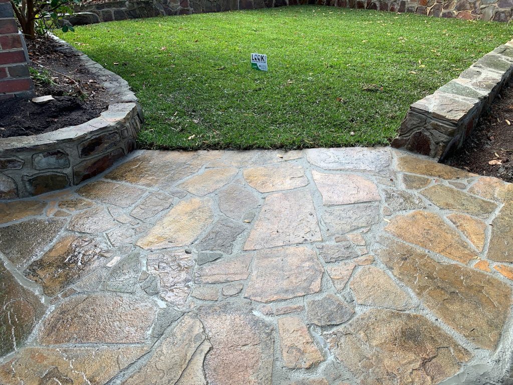 "Paved pathway through a landscaped garden"